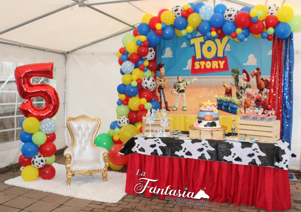 Package including a full balloon arrangement, decorations, main table, and desserts